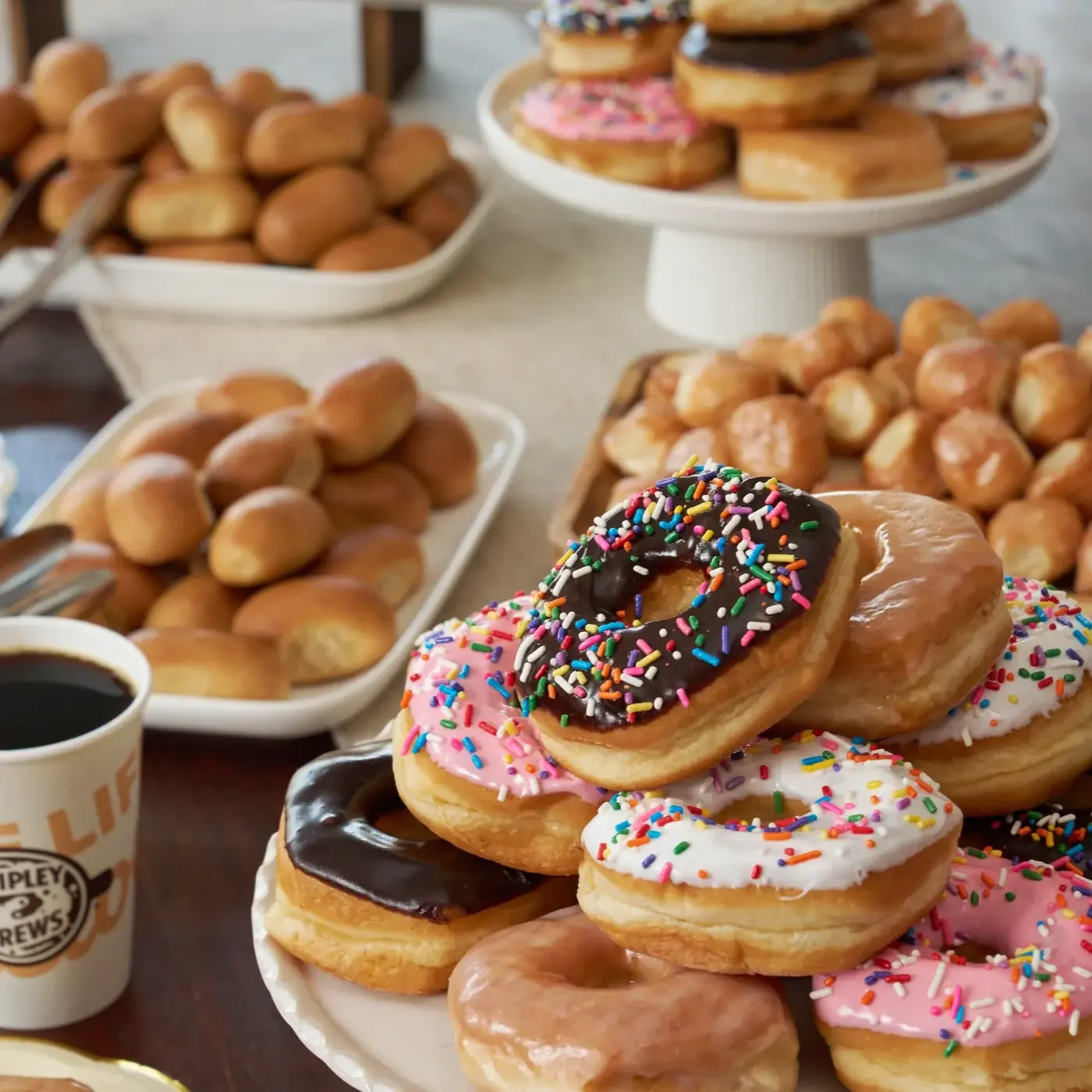 A spread of Shipley donuts, kolaches, donut holes and coffee